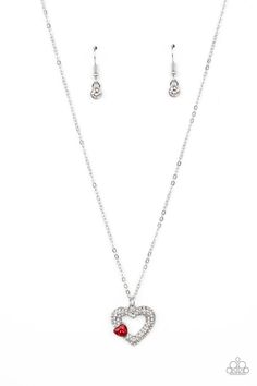 A luxurious airy silver heart lush with glassy white rhinestones swings from a classic silver chain. A faceted heart gem brushed in a red shimmer graces one side of the larger bedazzled heart for a romantic finish. Features an adjustable clasp closure.

 Sold as one individual necklace. Includes one pair of matching earrings. Heart Gem, Red Heart Necklace, Red Necklace, Paparazzi Accessories, Rhinestone Heart, White Rhinestone, Paparazzi Jewelry, Necklace Earring Set, Pendant Earrings