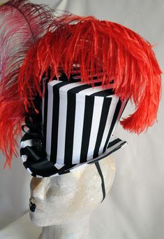 This extravagant vintage circus inspired ladies top hat is covered with a playful black and white striped cotton fabric and it is lusciously adorned with red and burgundy ostrich feathers.It is further trimmed with black ribbon and bow and a variety of buttons and clear crystals. Measurements : height 6.5 inches( 16 cm ) front to back 9 inches ( 23 cm ) side to side 8 inches ( 20 cm ) Need this but with feathers in another color? Just send me a message to talk about your options! THIS IS NOT A F Black Punk Top Hat For Alternative Fashion, Fitted Hats For Costume Party Carnival, Punk Mini Hat With High Crown For Costume Party, Black Punk Top Hat For Costume Party, Black Punk Style Top Hat For Costume Party, Punk Black Top Hat For Costume, Fitted Punk Top Hat For Party, Fitted Punk Style Top Hat For Party, Punk Style Fitted Top Hat For Party