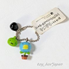 a keychain with an animal and a bird on it