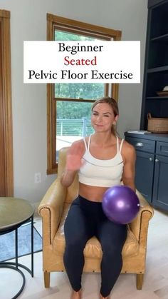 a woman sitting in a chair holding a purple ball