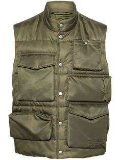 This quilted MM6 padded cargo vest showcases a modern utilitarian design with multiple front pockets and a band collar. The sleeveless style and front automatic button closure enhance comfort while ensuring a stylish look for various outings.

- Fully lined for comfort  
- Material: 100% polyester Cargo Vest, Padded Vest, City Shorts, Green Vest, Outerwear Vest, Vest White, Mm6 Maison Margiela, Band Collar, Summer Beach Wear