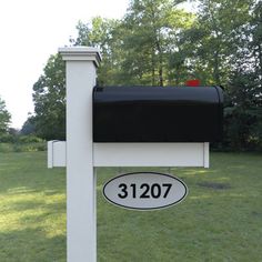 a mailbox with a black and white sign on it