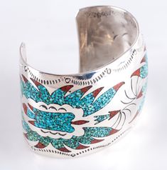 Vintage 1970's Sterling Silver Navajo Inlay Turquoise Coral Bird Cuff BraceletMetal Information: Sterling SilverTotal Weight: 85.3gBracelet Width: 2"Bracelet Length: 6" (Opening: 1.5")Circa: 1970'sArtist: B. EENStone InformationMain StoneGem Type: TurquoiseShape: InlayColor: Blue / GreenAccent StonesGem Type: CoralShape: InlayColor: RedEstimated Retail Price: $1400.00OUR PRICE: $1120.0044651 Southwestern Turquoise Bangle, Bohemian Turquoise Inlay Cuff Bracelet, Southwestern Turquoise Cuff Bracelet With Inlay, Southwestern Style Turquoise Cuff Bracelet With Inlay, Metal Cuff Bracelet, Jewelry Website, Coral Turquoise, Custom Jewelry Design, Metal Bracelets