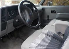 the interior of a vehicle with steering wheel and dashboard