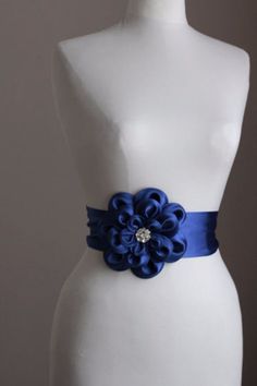 "An accessory to complement your beautiful wedding dress Made of satin. In the middle of the flower button is used the crystal. Flower size is approximately 6.5 \"dimensions. The belt length is approximately 80\"dimensions and made of satin. Flower fitted with lapel pins. Then, a flower can be used as a separate lapel pin. Please feel free to contact for questions and requests. PACKAGE ARE SENT BY FAST SHIPPING COMPANY WITHIN 3 TO 4 BUSINESS DAYS, TO UNITED STATES, TO CANADA, TO UNITED KINGDOM,T Flower Wedding Dress, Wedding Pen, Bridesmaid Sash, Wedding Dress Belt, Wedding Dresses With Flowers, Flower Button, Satin Flowers, Dress Belt, Flower Wedding