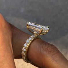 a woman's hand with a gold ring on it and a diamond band in the middle