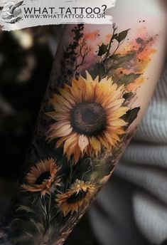 a sunflower tattoo on the arm with watercolors and leaves in front of it