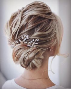 a woman with blonde hair wearing a wedding hairstyle