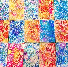 an art project made with colored paper and watercolors on the surface, including circles