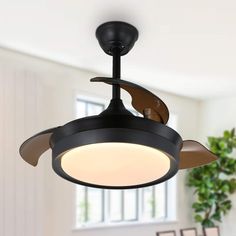 a black ceiling fan with two blades and a white light on the top of it