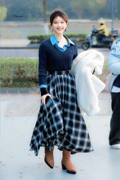 a woman is walking down the street with a large white teddy bear in her hand