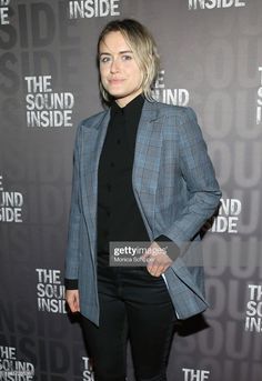 a woman standing in front of a wall with the words inside and outside on it