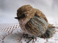 a small brown bird sitting on top of a table