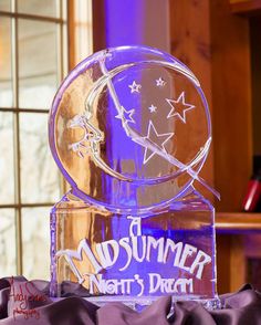 an ice sculpture with the words midsummer north's dream on it and stars in the sky