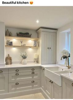 an image of a kitchen setting with white cupboards and counter tops in the middle