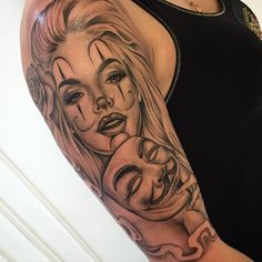 a woman's arm with tattoos on her face and two faces painted on it