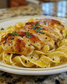 a white plate topped with chicken and pasta