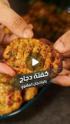 two hands holding food in front of a bowl