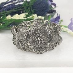 One of a Kind Handmade 925 Sterling Silver Artisan Crafted Filigree Adjustable Floral Cuff Bracelet Material: 925 Solid Sterling Silver, 925 Stamped Cuff Bracelet Weight: 35 Grams Bracelet Length: Adjustable to fit wrists 7 inches to 8.5 inches Bracelet Width: 1.60 inches Finishing: Oxidized & Polished Comes with a gift pouch and box Free Domestic Shipping Ornate Adjustable Sterling Silver Bangle, Adjustable Intricate Design Cuff Bracelet, Ceremonial Sterling Silver Elegant Bangle, Adjustable Sterling Silver Filigree Bangle, Adjustable Sterling Silver Filigree Cuff Bracelet, Unique Antique Silver Bracelet As Gift, Unique Antique Silver Bracelet For Gift, Adjustable Ornate Cuff Bracelet With Intricate Design, Ornate Adjustable Bracelets As Gifts