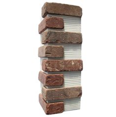 a stack of bricks sitting next to each other on top of a white wall and floor