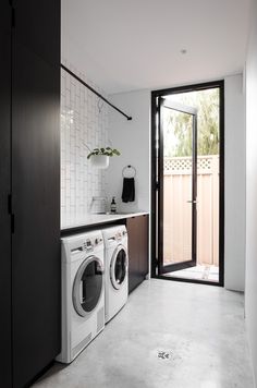 a washer and dryer in a small room next to a sliding glass door