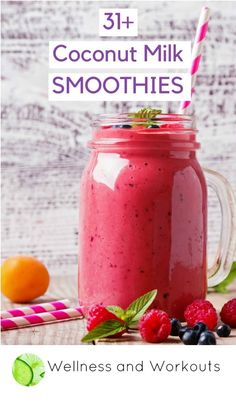 a smoothie in a mason jar with strawberries and raspberries on the side