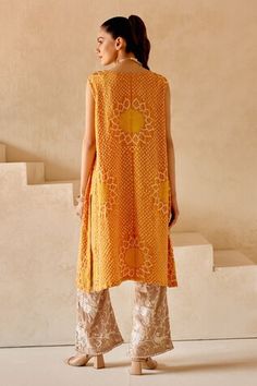 Orange shift dress kurta with sunflower patterns in crushed bandhani work and side button down panels. - Aza Fashions Sleeveless Chanderi Dress With Mirror Work, Sleeveless Chanderi Dress With Chikankari Embroidery, Sleeveless Chikankari Chanderi Dress, Festive Yellow Sleeveless Kurta, Sleeveless Kurta With Chikankari Embroidery For Transitional Season, Chanderi Sleeveless Dresses For Festivals, Sleeveless Dress With Dupatta For Navratri, Festival Sleeveless Chanderi Dresses, Festive Sleeveless Bandhani Print Set