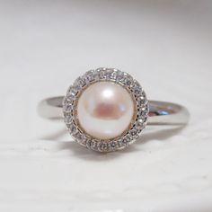 Material: solid sterling silver, Rhodium plated, cubic zircon Required pearl:6-7mm (the pearl in the picture is 6mm round pearl) Size: adjustable 0.9mm pin for half drilled pearl or bead The listed price is only for the setting, without any pearl or bead DISCOUNTS ON LARGE ORDERS Get 10% off for order $50-$99 Get 15% off for order $99-$199 Get 20% off for order $200-$399 Get 25%off for order $400 and more For order over 300 dollars will be shipped by FEDEX or TNT for free. All the discounts will Silver Pearl Ring With Prong Setting, Cubic Zirconia Pearl Ring With Halo Setting, Pearl Ring With Halo Setting And Cubic Zirconia, Silver Solitaire Pearl Ring, Silver Round Solitaire Pearl Ring, Silver Pearl Ring With Center Stone And Round Cut, Silver Diamond Pearl Ring With Halo Setting, Anniversary Pearl Ring With Halo Setting And Cubic Zirconia, Pearl Promise Ring With Halo Setting