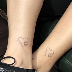 two people with matching tattoos on their feet, one has a dog and the other has a cat