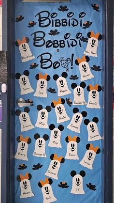 a door decorated with mickey mouse heads and ghost faces for halloween time at disney world