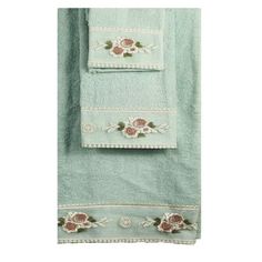 two towels with embroidered roses on them and one towel folded in the same direction,