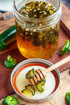 a jar filled with pickled jalapenos on top of a wooden cutting board