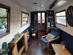 a living room filled with furniture and a fire place in the corner next to a window