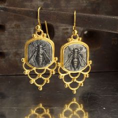 "These exquisite Ancient Roman Art Handcrafted Dangle Bee Blacked Coin Earrings are meticulously made by the skilled artisans at Makeitbylove Workshop in Bodrum, Turkey. Crafted with attention to detail, these earrings showcase the beauty of ancient Roman art. The earrings are made of 925k sterling silver and feature blacked/oxidized coins, replicating the look of ancient time jewelry. The earrings measure 40 mm (1.39 \") in length, 16 mm in width, and have a weight of 10.20 grams. They are adorned with sparkling white topaz gemstones, adding a touch of elegance. The coins used in our designs are reproductions of original ancient Roman coins, made with 125k silver for the oxidation process. Ancient Bee Jewelry: Bees have held symbolic significance in ancient cultures, representing industri