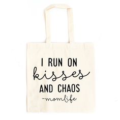 a tote bag with the words i run on kisses and chaos in black ink