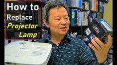 a man holding up a projector lamp in front of a bookshelf with the words how to replace