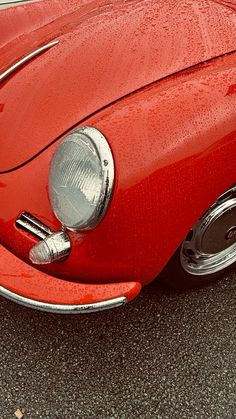 the front end of an old red car