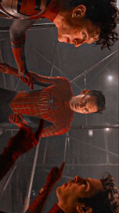 the amazing spider - man is standing in front of two other men