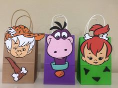 three paper bags with cartoon characters on them