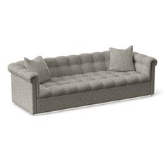 a gray couch with pillows on top of it