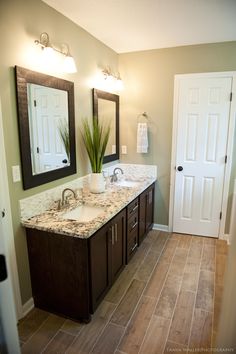 a bathroom with two sinks and mirrors in it