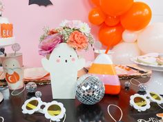 a table topped with lots of party decorations and decorating items on top of it