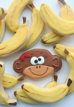 cookies decorated to look like bananas with a monkey face