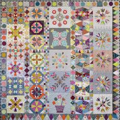 a quilt made with many different colors and shapes