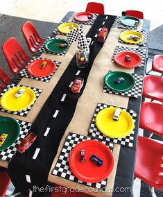 the table is set with race cars plates and napkins for racing themed birthday party