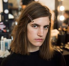 a woman with long hair is getting her hair cut