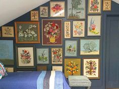 a bedroom with blue walls and pictures on the wall