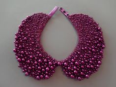 a purple beaded necklace with pink beads