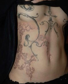 a woman with tattoos on her stomach