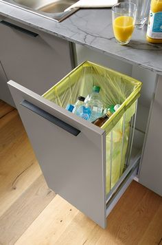 an open drawer in a kitchen next to a counter